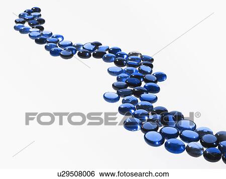 Stock Photograph - Studio shot of blue glass beads in row. Fotosearch