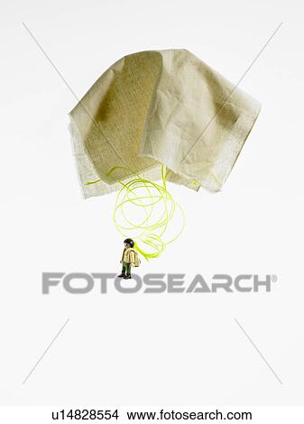 Picture - Studio shot of figurine with paper parachute. Fotosearch