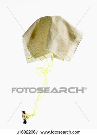 Stock Photo - Studio shot of figurine with paper parachute. Fotosearch