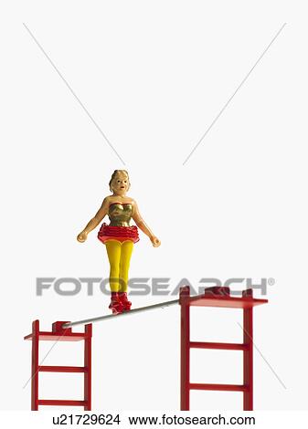 Picture - Studio shot of figurines on ladders. Fotosearch
