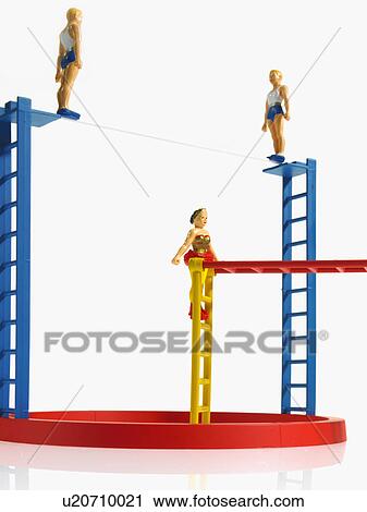 Stock Image - Studio shot of figurines on ladders. Fotosearch