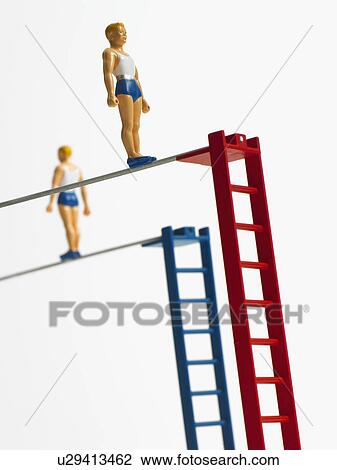 Stock Image - Studio shot of figurines on ladders. Fotosearch