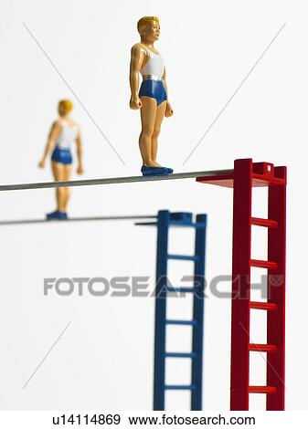 Stock Photo - Studio shot of figurines on ladders. Fotosearch