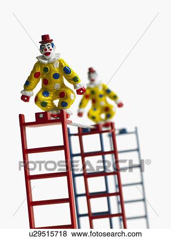 Stock Photo - Studio shot of figurines on ladders. Fotosearch