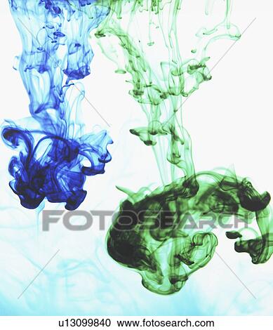 Stock Image - Studio shot of green and blue dye in abstract shape. Fotosearch