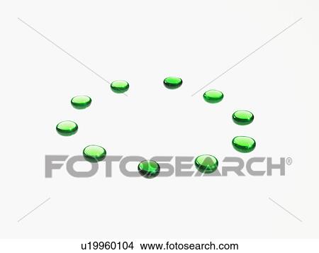 Picture - Studio shot of green glass beads in circle. Fotosearch