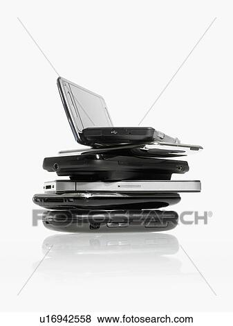 Stock Photo - Studio shot of pile of laptops and palmtops. Fotosearch
