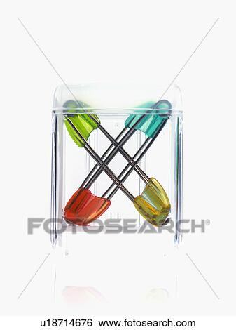 Stock Photograph - Studio shot of safety pins in glass cube. Fotosearch