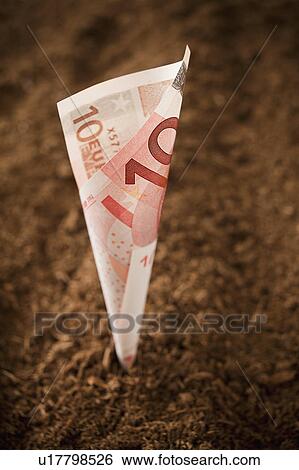 Stock Photograph - Ten euros Banknote growing from dirt, studio shot. Fotosearch