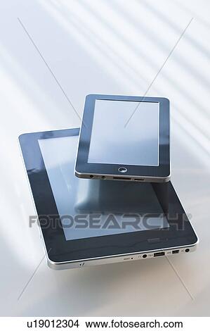 Picture - Two digital tablets reflecting light. Fotosearch