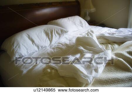 Unmade bed with white duvet View Large Photo Image Stock Photography - Unmade bed with white duvet. Fotosearch