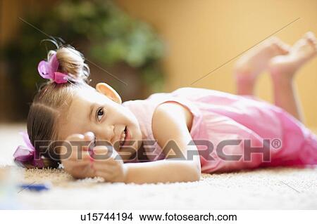 USA, Arizona, Chandler, Cute girl (2-3) wearing pink dress lying on floor View Large Photo Image Picture - USA, Arizona, Chandler, Cute girl (2-3) wearing pink dress lying on floor. Fotosearch