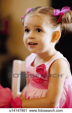 Stock Image - USA, Arizona, Chandler, Portrait of cute girl (2-3) wearing pink dress. Fotosearch