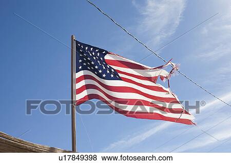 Stock Photo - USA, Arizona, Winslow, American flag on wind. Fotosearch