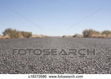 Stock Photograph - USA, Arizona, Winslow, Country road, surface level. Fotosearch