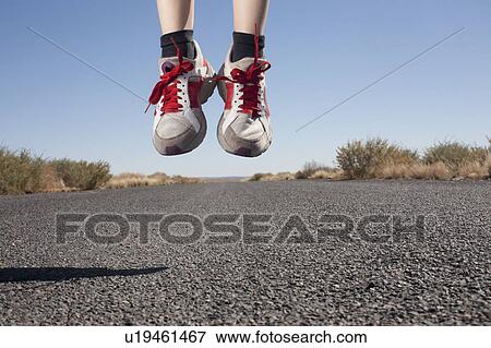USA, Arizona, Winslow, Human feet in sport shoes jumping View Large Photo Image Stock Photo - USA, Arizona, Winslow, Human feet in sport shoes jumping. Fotosearch