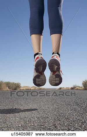 USA, Arizona, Winslow, Mid adult woman jumping, low section View Large Photo Image Stock Photo - USA, Arizona, Winslow, Mid adult woman jumping, low section. Fotosearch