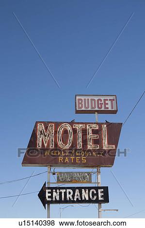 Stock Photo - USA, Arizona, Winslow, Old-fashioned motel sign against blue sky. Fotosearch