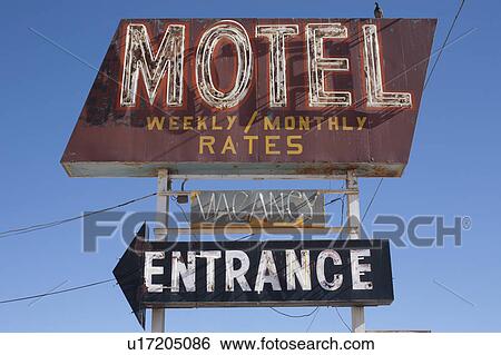 Stock Photograph - USA, Arizona, Winslow, Old-fashioned motel sign against blue sky. Fotosearch