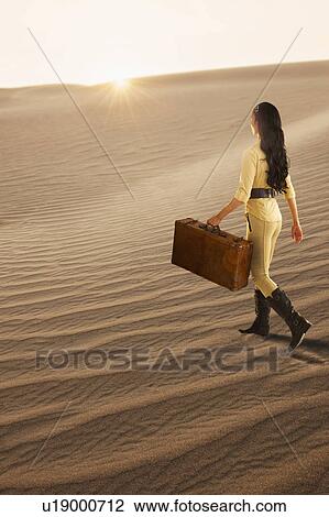 USA, California, Death Valley, Woman with suitcase walking in desert View Large Photo Image Stock Image - USA, California, Death Valley, Woman with suitcase walking in desert. Fotosearch