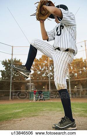 Stock Photograph - USA, California, Ladera Ranch, boy (10-11) playing baseball. Fotosearch