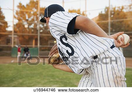 Stock Photograph - USA, California, Ladera Ranch, boy (10-11) playing baseball. Fotosearch