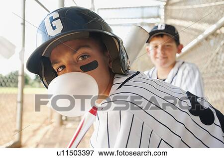 Stock Photo - USA, California, Ladera Ranch, boys (10-11) from little league baseball team on dugout. Fotosearch