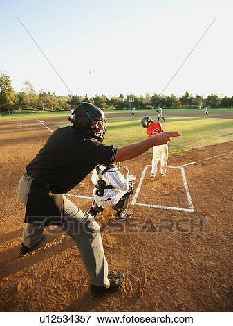 Stock Photo - USA, California, Ladera Ranch, boys (10-11) playing baseball. Fotosearch