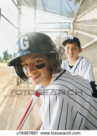 Stock Photo - USA, California, Ladera Ranch, boys (10-11) from little league baseball team on dugout. Fotosearch