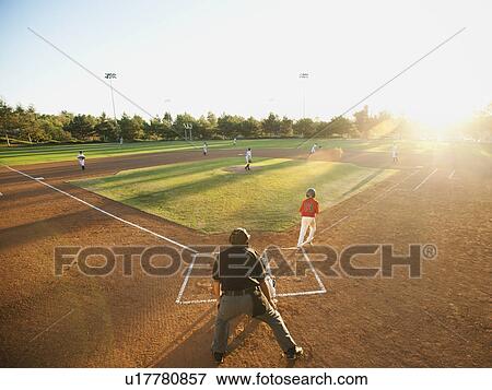 Stock Photo - USA, California, Ladera Ranch, boys (10-11) playing baseball. Fotosearch