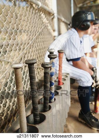 Stock Photo - USA, California, Ladera Ranch, Boys (10-11) from little league sitting on dugout. Fotosearch