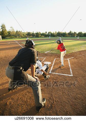 Stock Photo - USA, California, Ladera Ranch, boys (10-11) playing baseball. Fotosearch