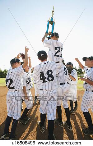Stock Photograph - USA, California, Ladera Ranch, Boys (10-11) from Little league celebrating after winning. Fotosearch