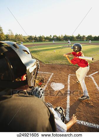 Stock Photography - USA, California, Ladera Ranch, boys (10-11) playing baseball. Fotosearch