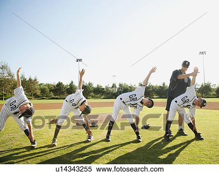 Stock Photography - USA, California, Ladera Ranch, Coach training boys (10-11) from little league. Fotosearch