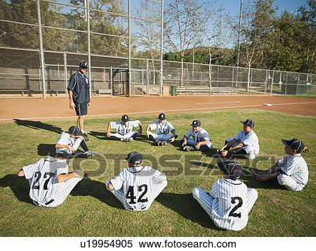 Stock Photography - USA, California, Ladera Ranch, Coach training boys (10-11) from little league. Fotosearch