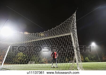 Stock Image - USA, California, Ladera Ranch, Football player preparing for penalty kick. Fotosearch