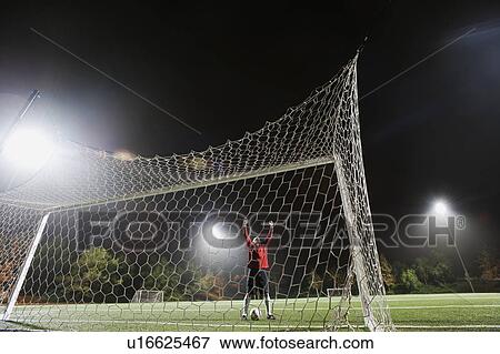 Stock Photo - USA, California, Ladera Ranch, Football player preparing for penalty kick. Fotosearch