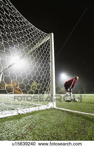 USA, California, Ladera Ranch, goalie on illuminated soccer field at night View Large Photo Image Stock Image - USA, California, Ladera Ranch, goalie on illuminated soccer field at night. Fotosearch