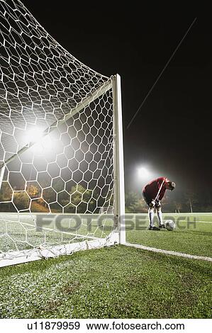 USA, California, Ladera Ranch, goalie on illuminated soccer field at night View Large Photo Image Stock Photo - USA, California, Ladera Ranch, goalie on illuminated soccer field at night. Fotosearch