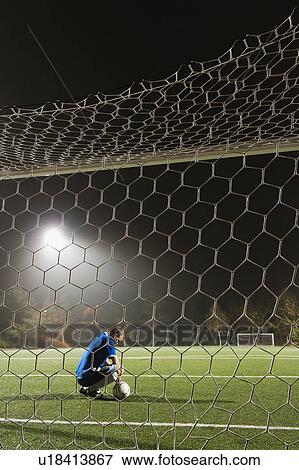 USA, California, Ladera Ranch, goalie on illuminated soccer field at night View Large Photo Image Stock Photo - USA, California, Ladera Ranch, goalie on illuminated soccer field at night. Fotosearch