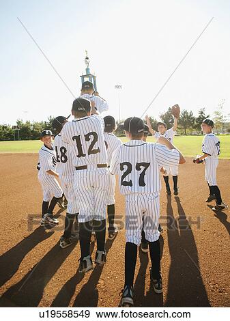 Stock Photo - USA, California, Ladera Ranch, little league players (aged 10-11) celebrating. Fotosearch