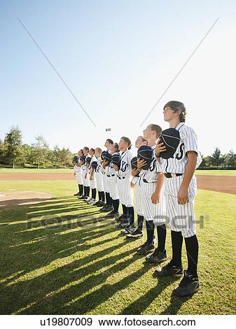 Stock Photo - USA, California, Ladera Ranch, little league players (aged 10-11) on field. Fotosearch