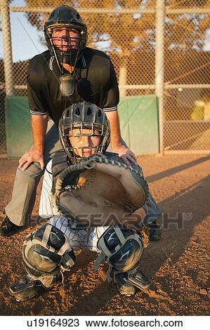Stock Image - USA, California, Ladera Ranch, man and boy (10-11) playing baseball. Fotosearch