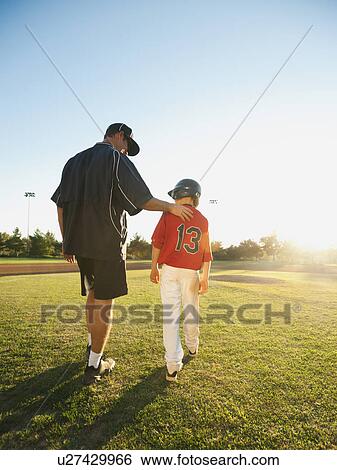 USA, California, Ladera Ranch, man and boy (10-11) walking on baseball field View Large Photo Image Stock Photograph - USA, California, Ladera Ranch, man and boy (10-11) walking on baseball field. Fotosearch