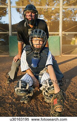 Stock Photography - USA, California, Ladera Ranch, man and boy (10-11) playing baseball. Fotosearch