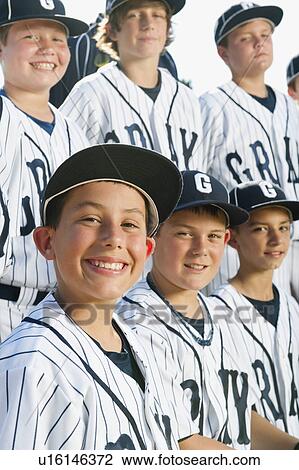 Stock Image - USA, California, Ladera Ranch, portrait of little league players (aged 10-11). Fotosearch