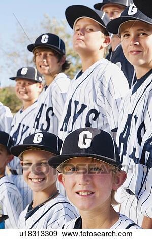 Stock Photo - USA, California, Ladera Ranch, portrait of little league players (aged 10-11). Fotosearch