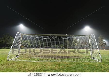 Stock Image - USA, California, Ladera Ranch, illuminated soccer field at night. Fotosearch