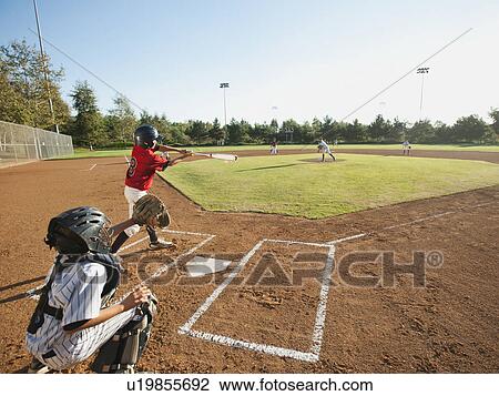 Stock Image - USA, California, little league baseball team (10-11) during baseball match. Fotosearch